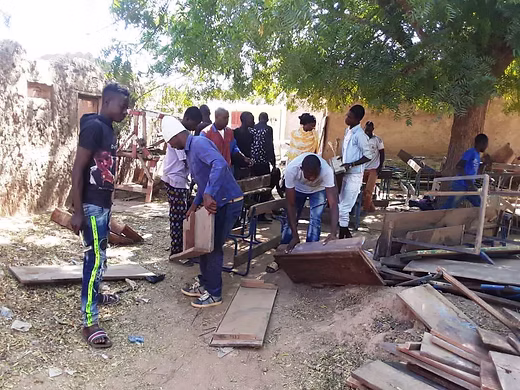 Young Adults repairing desks 1